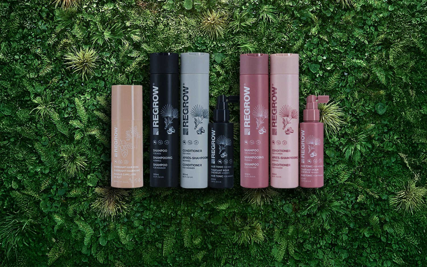 Set of hair care products on a green grass background