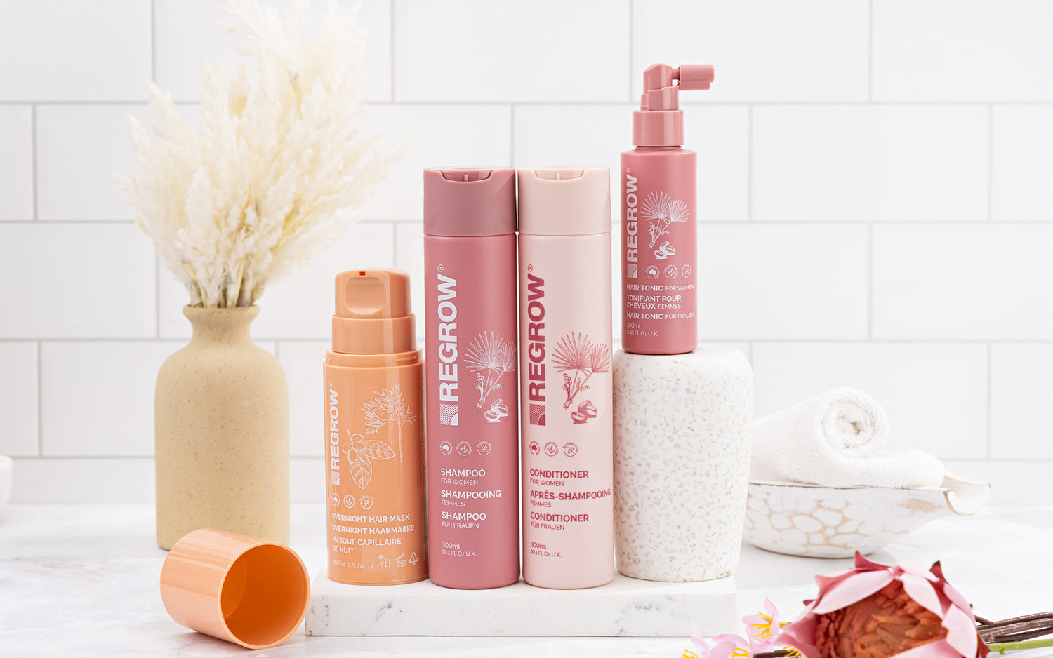 Beregrow hair care products on a white surface with a tiled wall background